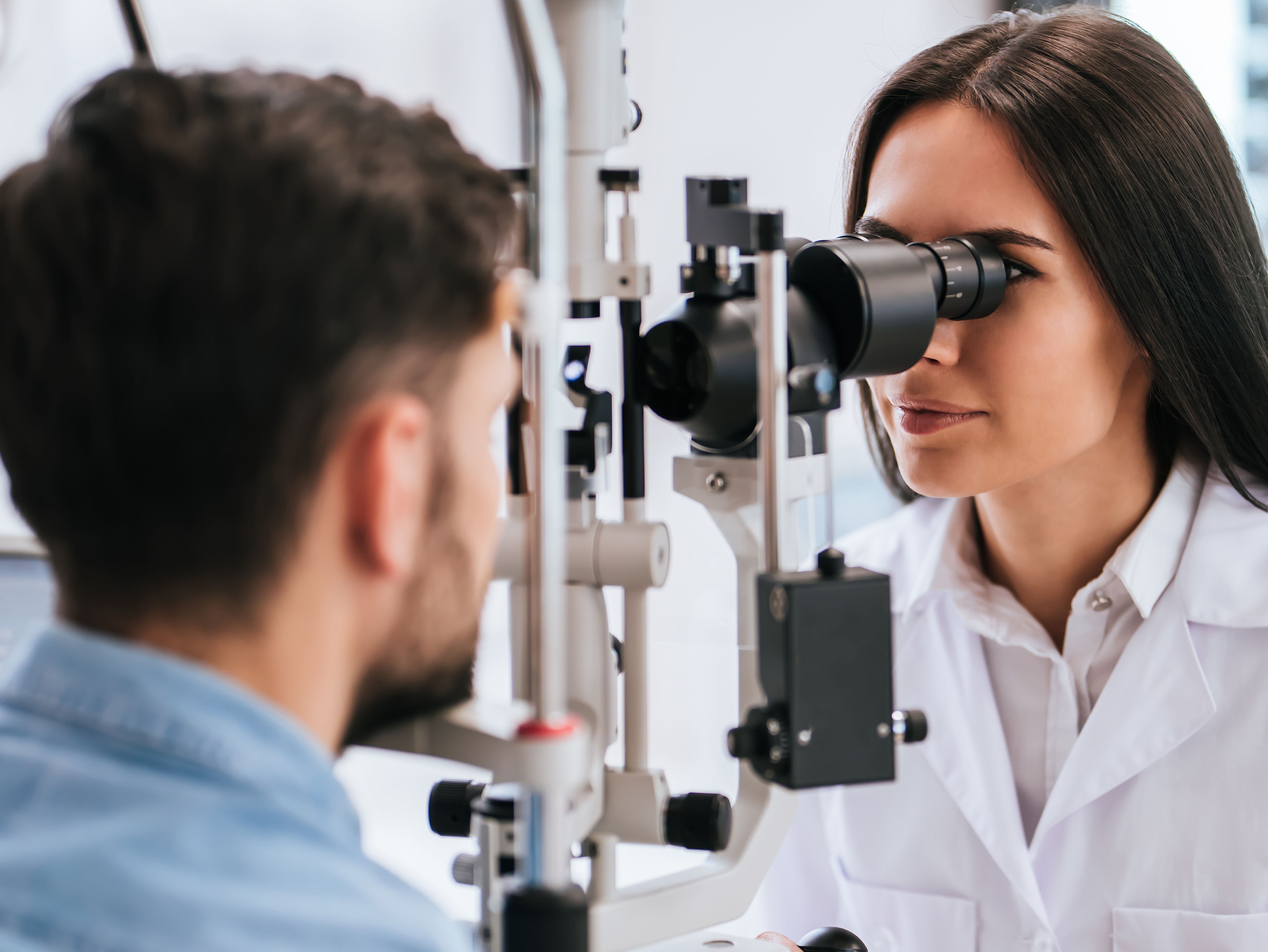 Optician conducting eye test
